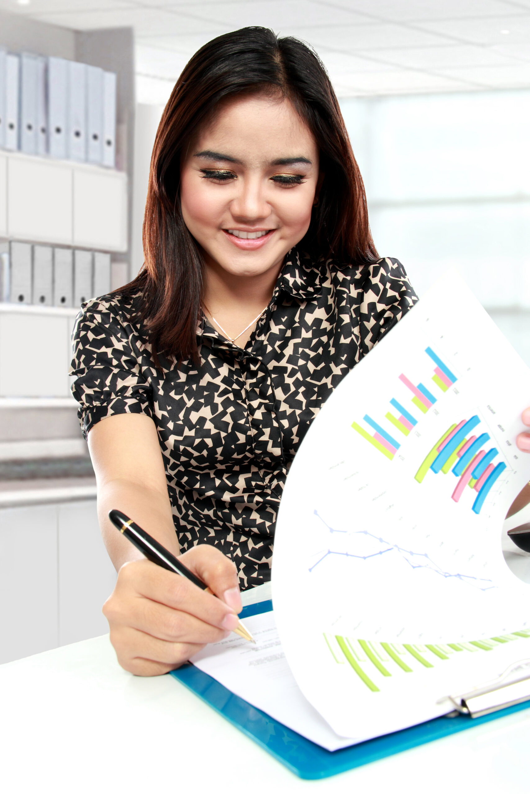 Portrait of young businesswoman working with papers in office
