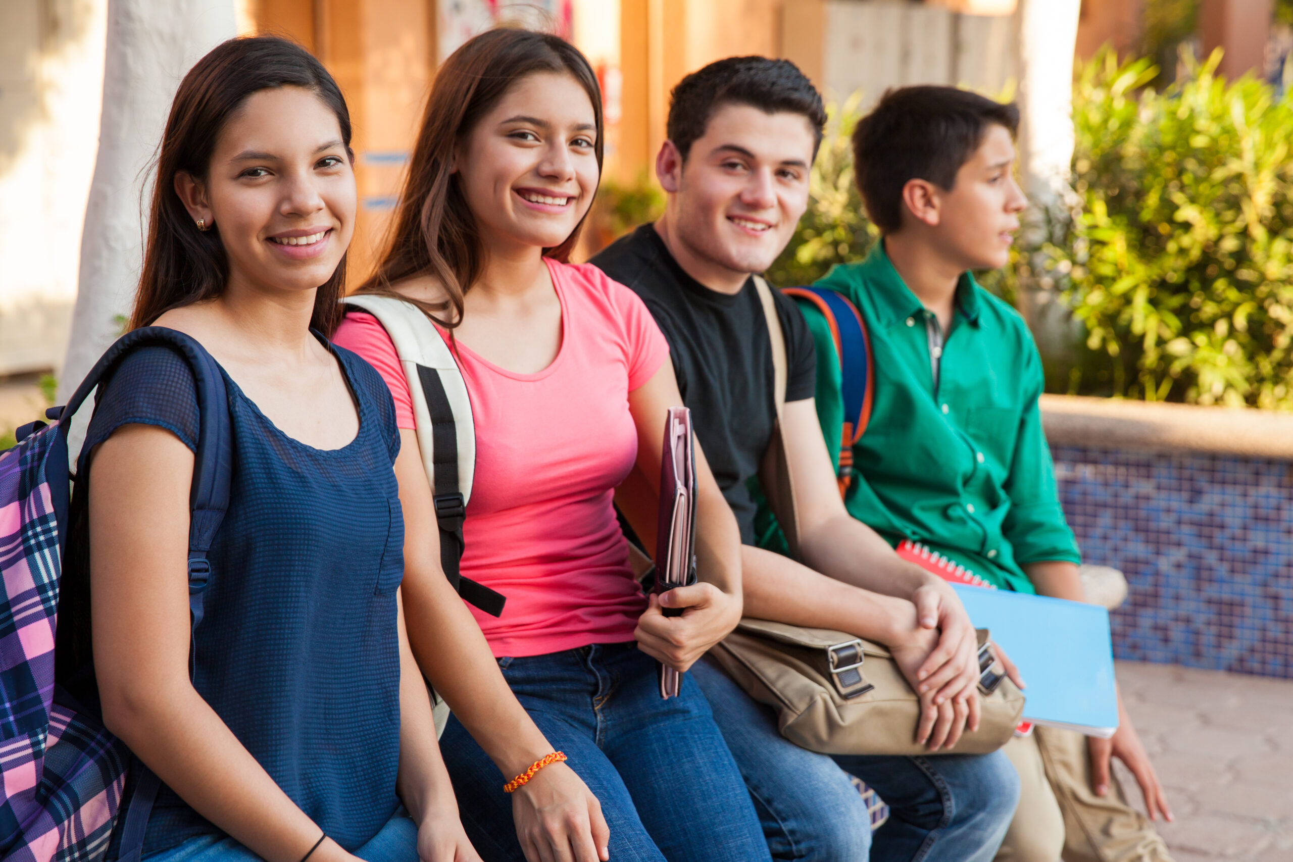 Hanging out at school Groupo of four teenage friends hanging out in high school
