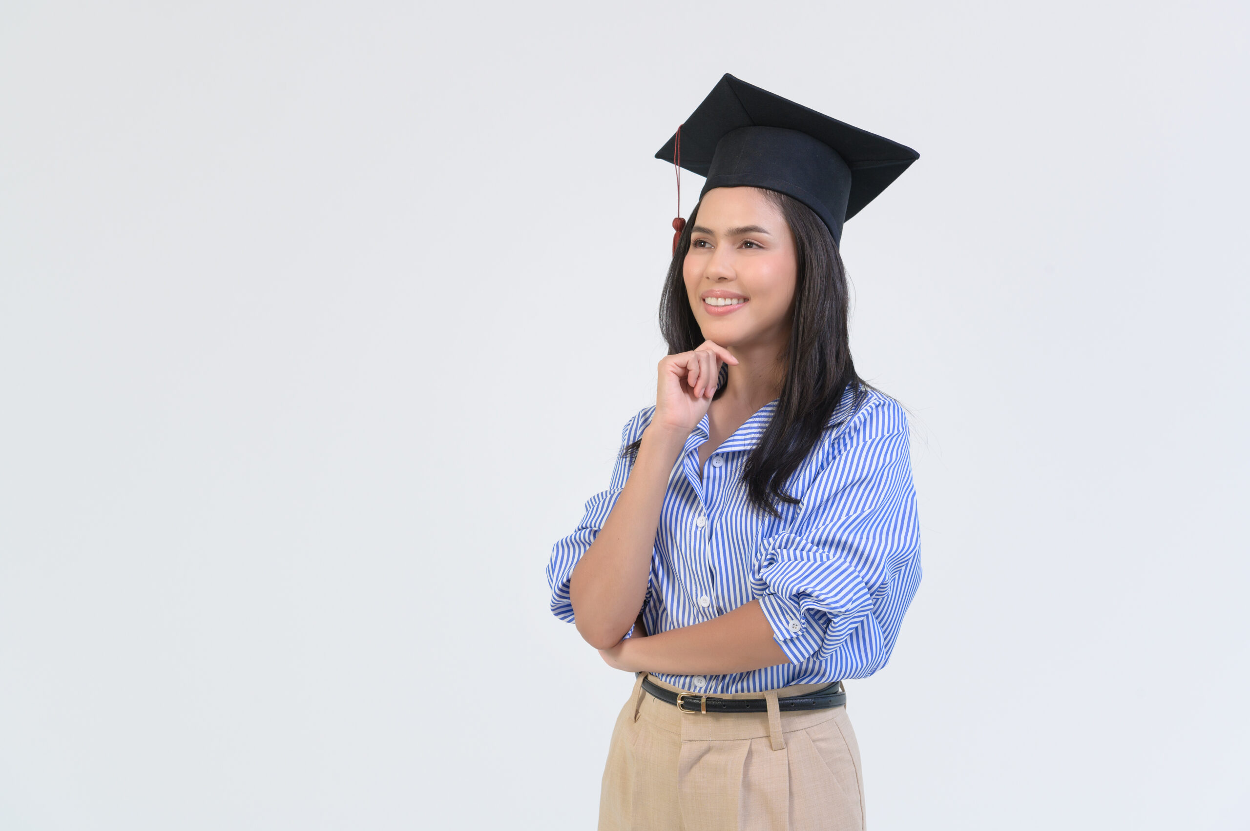 Portrait of happy Beautiful woman in graduation gown over white background Portrait of happy Beautiful woman in graduation gown over white background